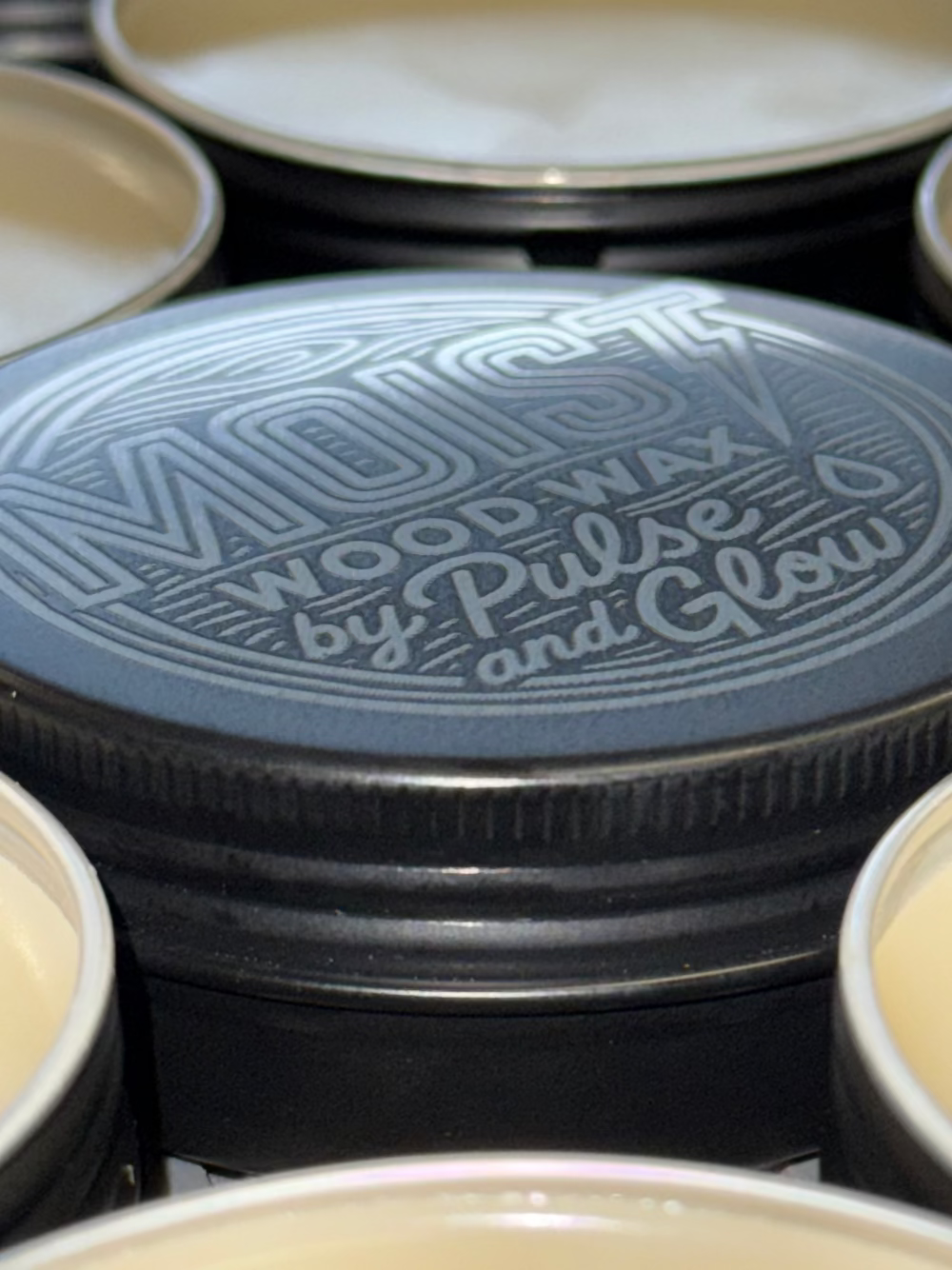 Close-up of a container lid with branding text, surrounded by other containers.